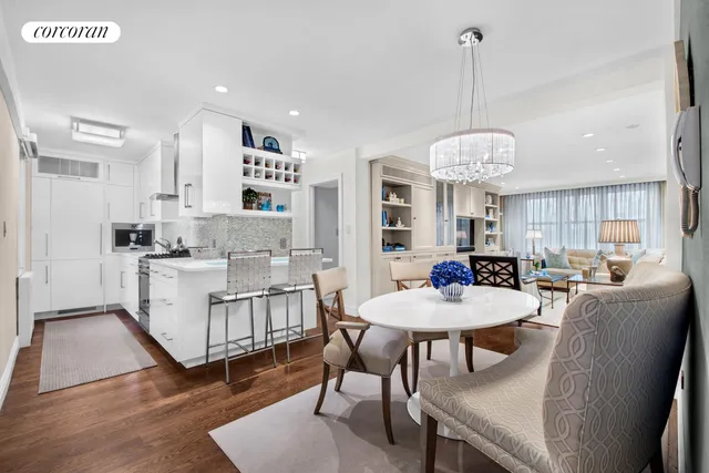 a view of a dining room and livingroom with furniture wooden floor a rug