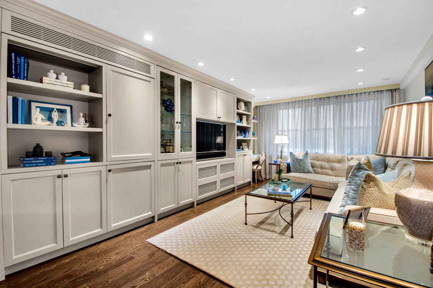241 East 76th Street, Unit 2HI Manhattan, NY 10021 - Photo 17 of 27 a living room with furniture and a flat screen tv