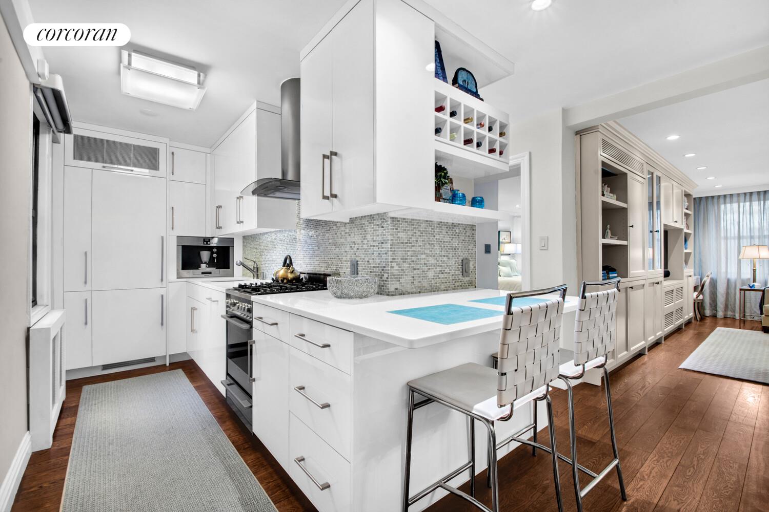 241 East 76th Street, Unit 2HI Manhattan, NY 10021 - Photo 2 of 27 a kitchen with stainless steel appliances granite countertop a white cabinets and a refrigerator