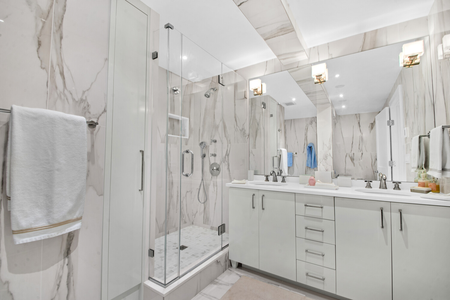 241 East 76th Street, Unit 2HI Manhattan, NY 10021 - Photo 20 of 27 a bathroom with a double vanity sink mirror and double