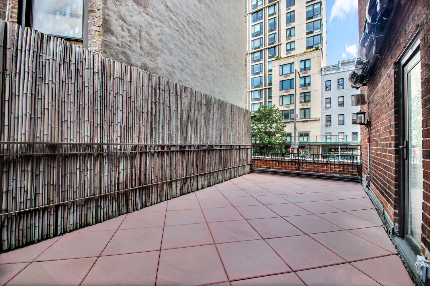 241 East 76th Street, Unit 2HI Manhattan, NY 10021 - Photo 24 of 27 a view of a balcony with wooden fence