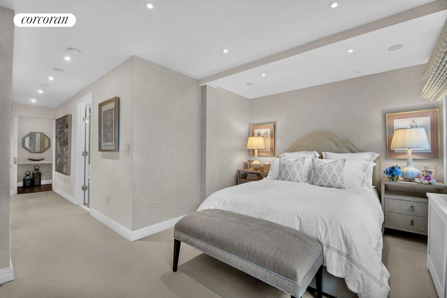 241 East 76th Street, Unit 2HI Manhattan, NY 10021 - Photo 6 of 27 a bedroom with a bed and a couch