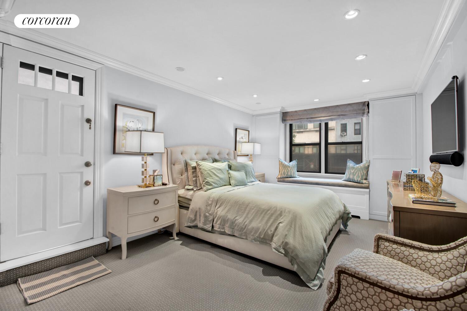 241 East 76th Street, Unit 2HI Manhattan, NY 10021 - Photo 9 of 27 a bedroom with a bed and a couch