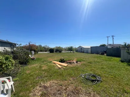 a view of a backyard with table and chairs