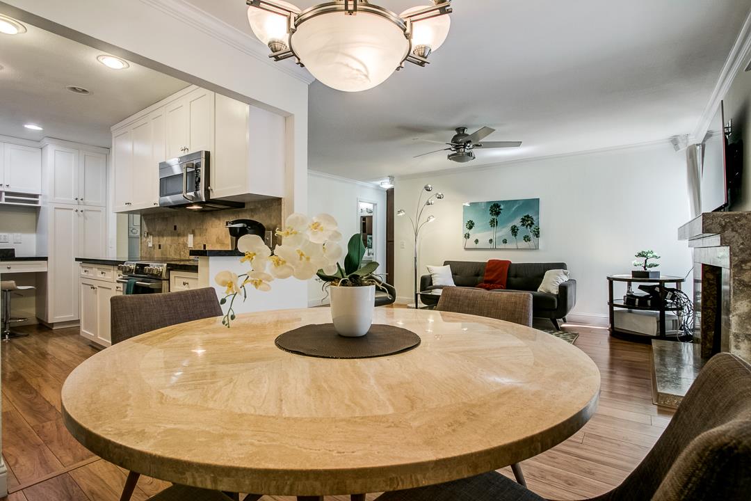 1049 Shell Boulevard, Unit 3 Foster City, CA 94404 - Photo 11 of 56 a dining room with kitchen view wooden floor and stainless steel appliances