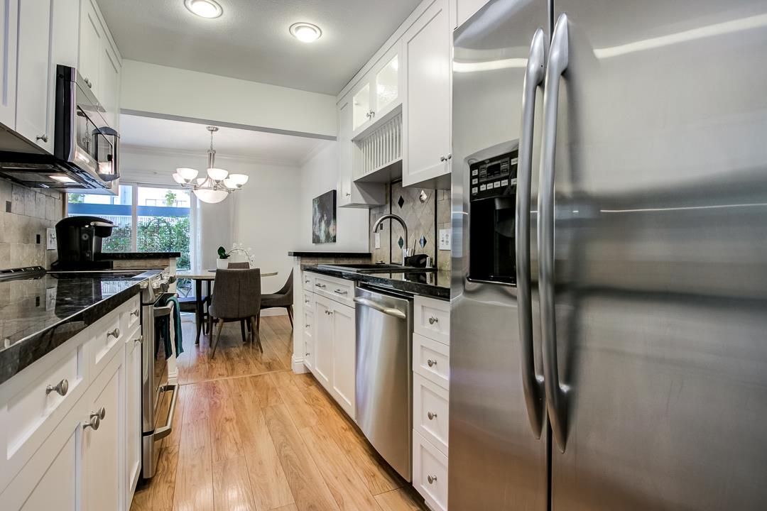 1049 Shell Boulevard, Unit 3 Foster City, CA 94404 - Photo 12 of 56 a kitchen with granite countertop a refrigerator stove top oven and sink
