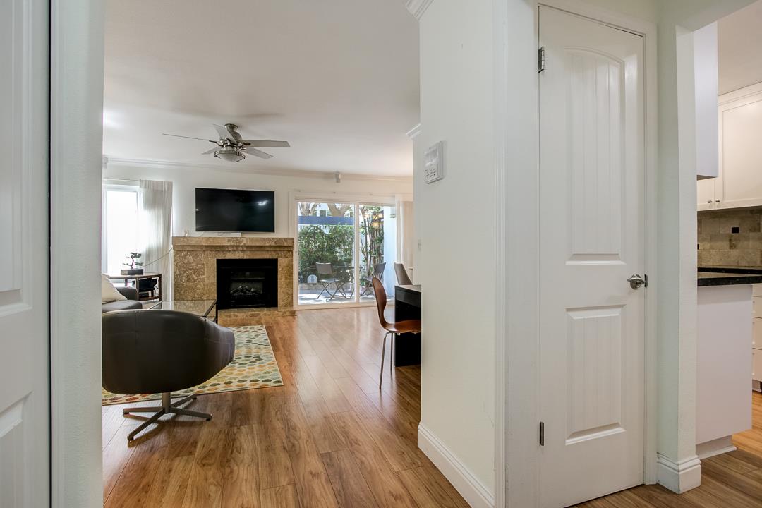 1049 Shell Boulevard, Unit 3 Foster City, CA 94404 - Photo 2 of 56 a living room with furniture a fireplace and a flat screen tv