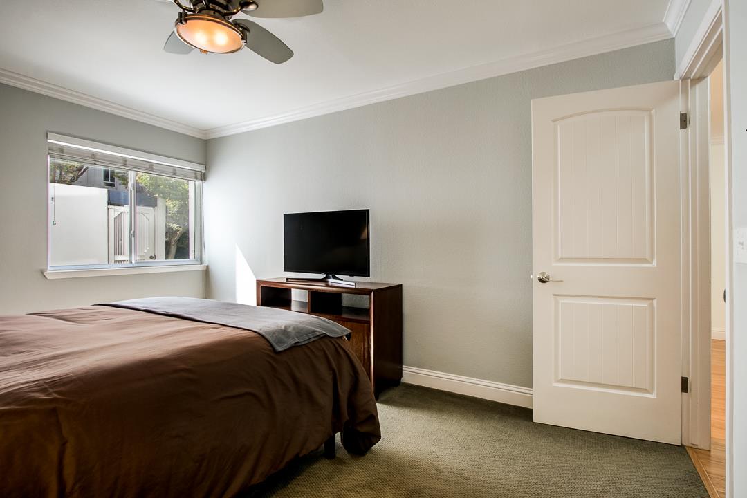 1049 Shell Boulevard, Unit 3 Foster City, CA 94404 - Photo 24 of 56 a bedroom with a bed and a flat screen tv