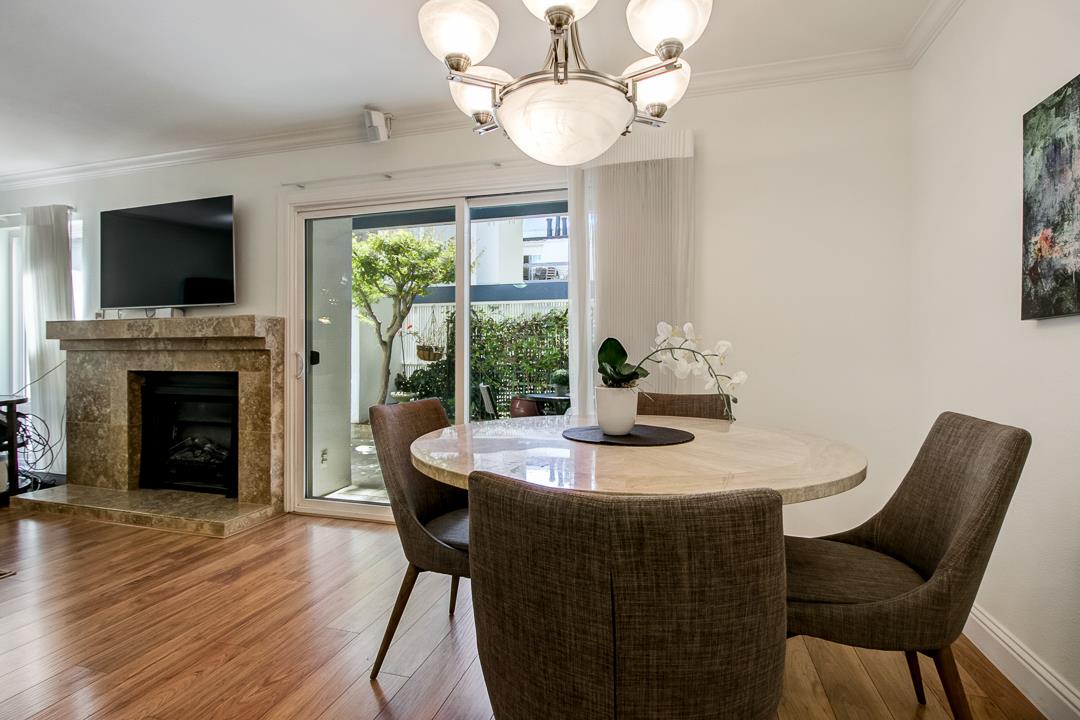 1049 Shell Boulevard, Unit 3 Foster City, CA 94404 - Photo 8 of 56 a dining room with furniture a fireplace and large windows