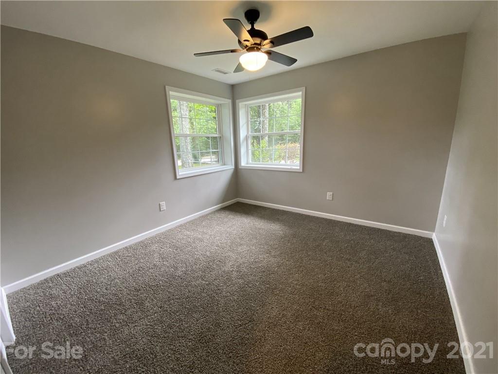 629 Thompson Road Rutherfordton, NC 28139 - Photo 9 of 10 an empty room with windows and ceiling fan