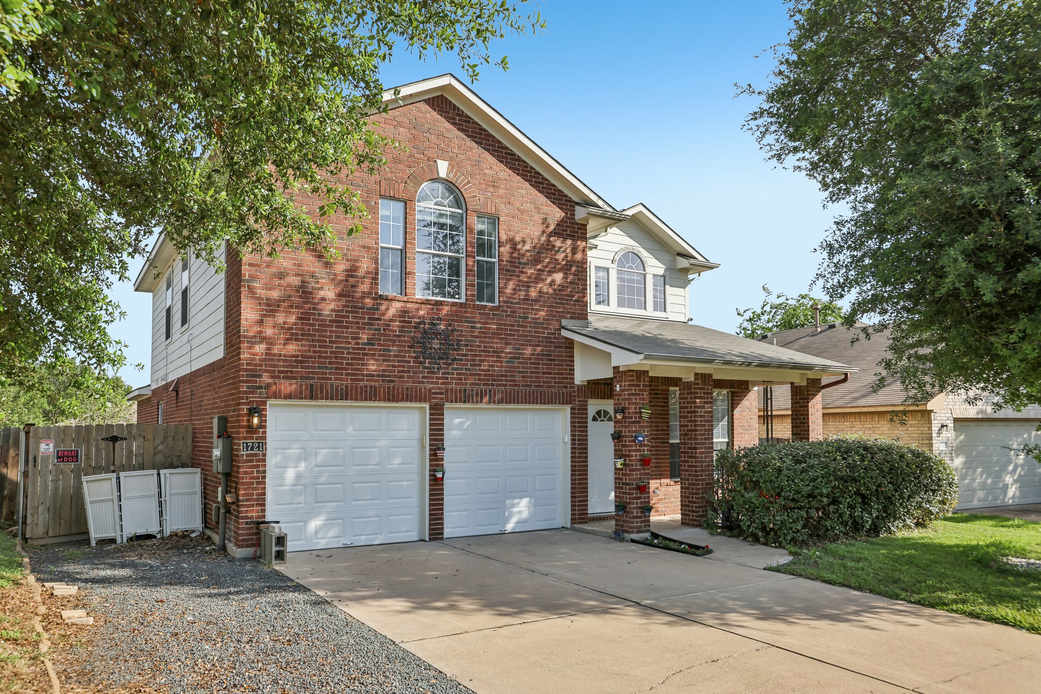 1721 Long Rifle Drive Austin, TX 78754 - Photo 3 of 38 A classic brick facade with a columned entry welcomes you to this inviting residence.