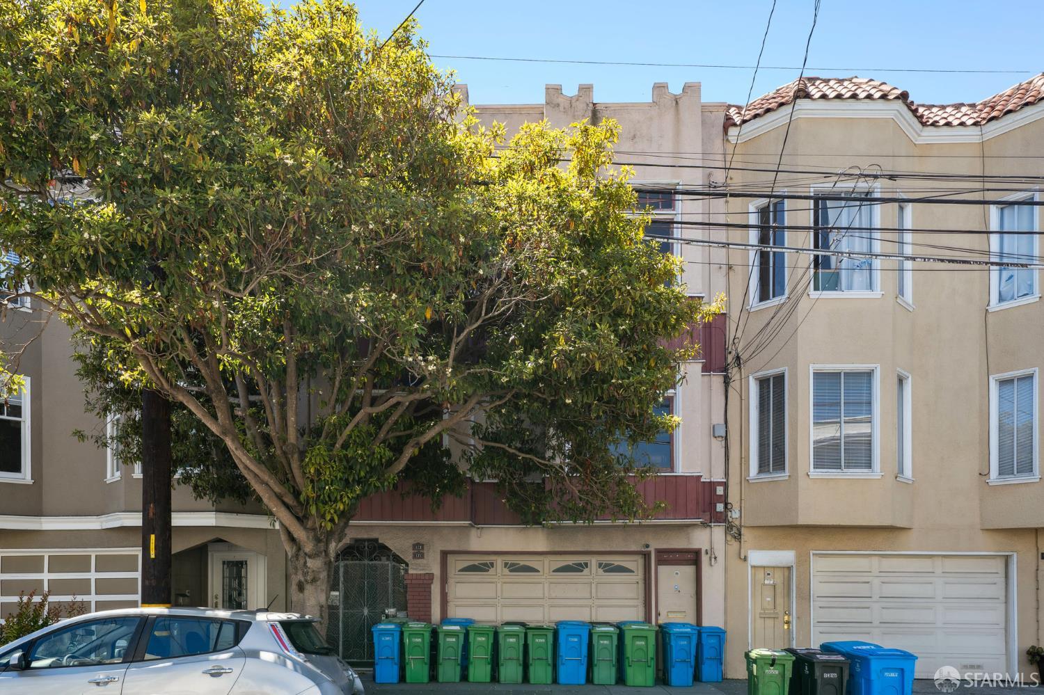 a front view of a residential apartment building with a yard