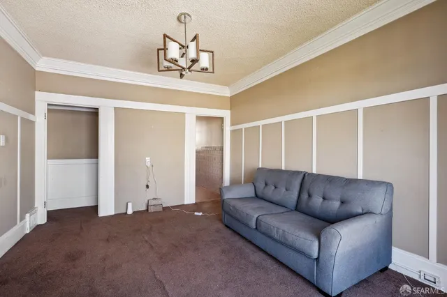 a living room with furniture and a chandelier