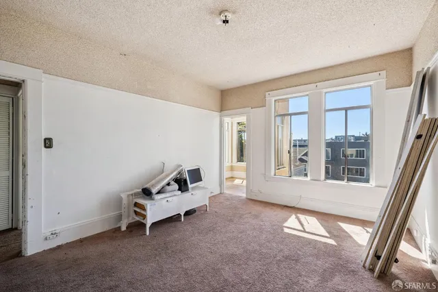 a living room with furniture and windows