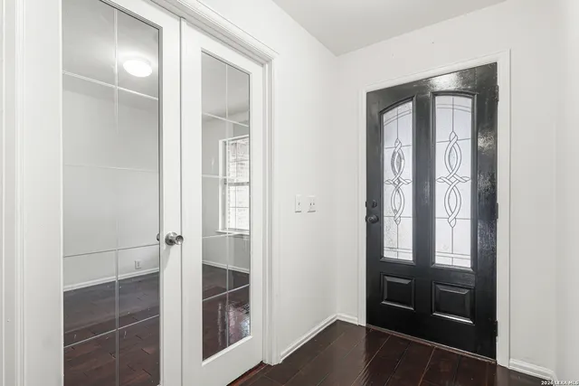 a bathroom with a glass door shower and a sink
