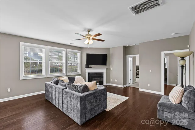 a living room with furniture fireplace and flat screen tv
