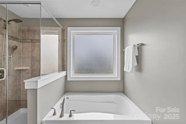 a bathroom with a tub shower and sink