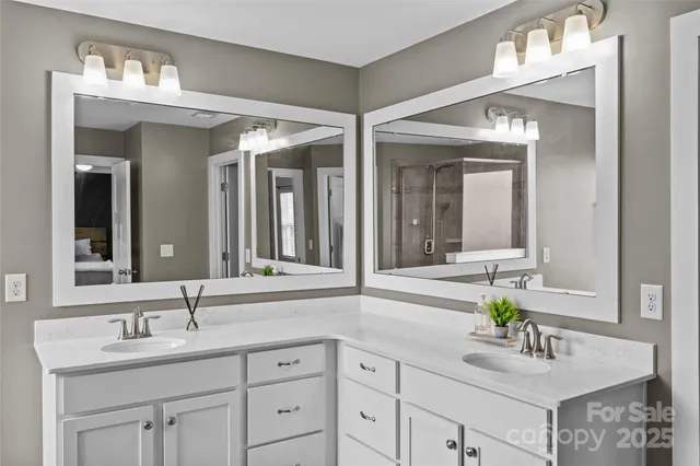 a bathroom with double sink and a mirror
