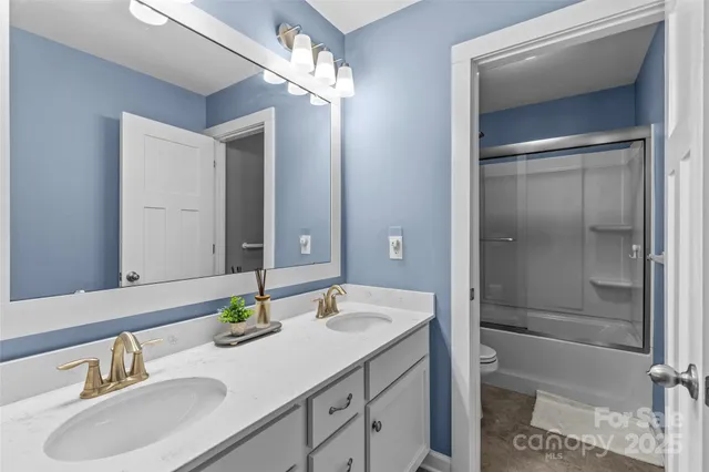 a bathroom with a sink double vanity and a mirror