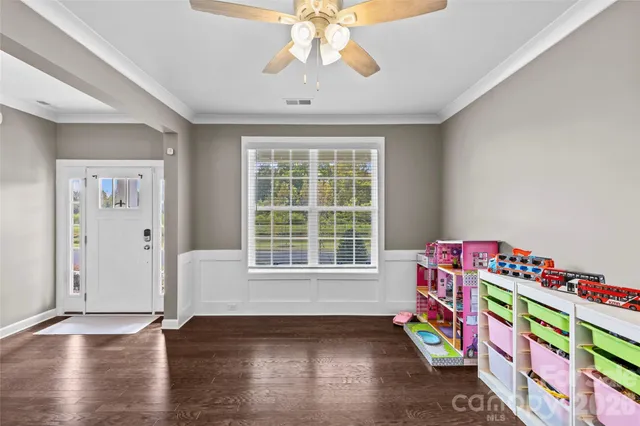 a very nice looking room with wooden floor and furniture