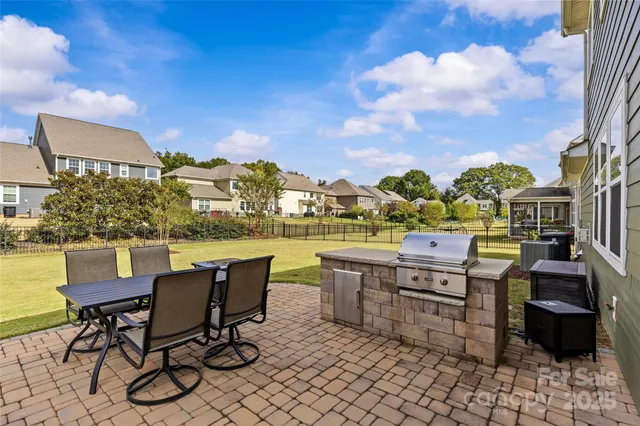 a view of a chairs and table in patio
