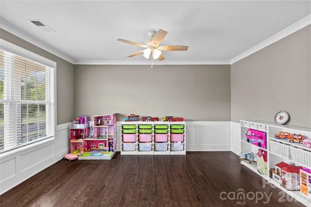 a play room with toys and wooden floor