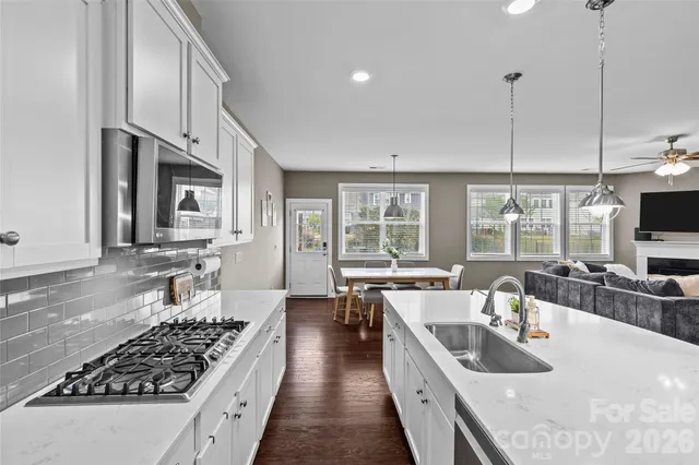 a kitchen with stainless steel appliances a stove sink and cabinets
