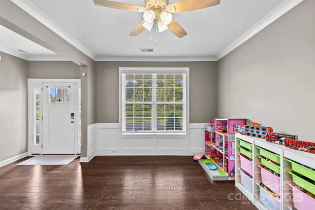 a very nice looking room with wooden floor and furniture