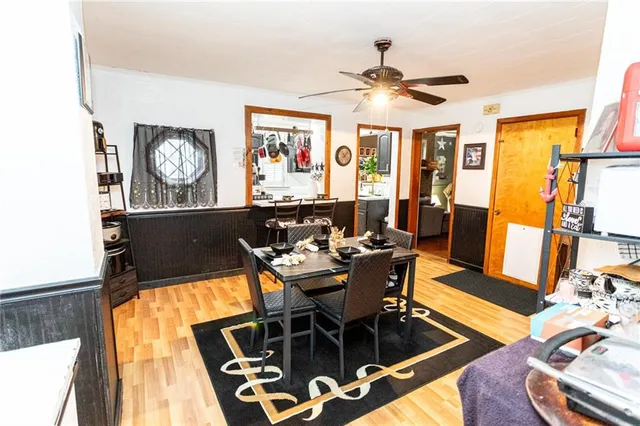 a view of a dining room with furniture a chandelier and wooden floor