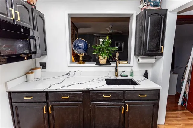 a sink and a mirror in a kitchen