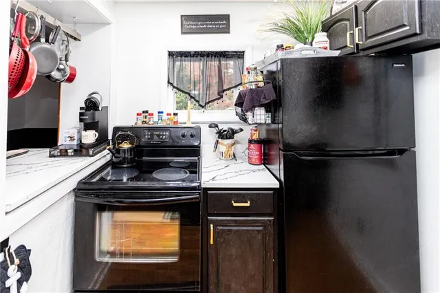 a kitchen with a refrigerator and a stove