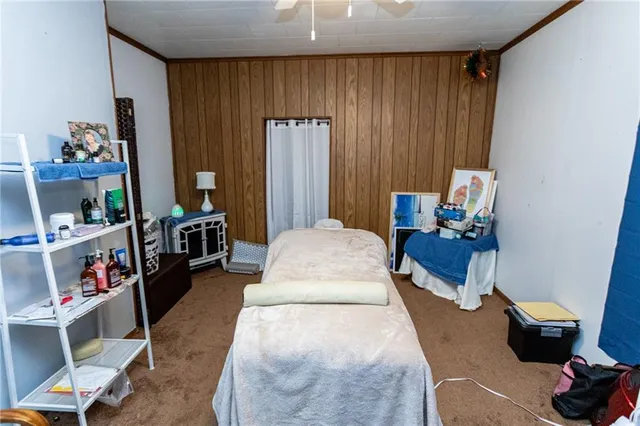 a living room with furniture and a book shelf