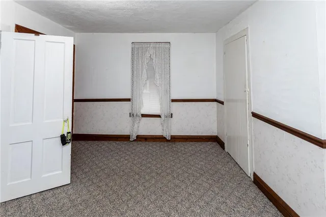 a view of an empty room with closet