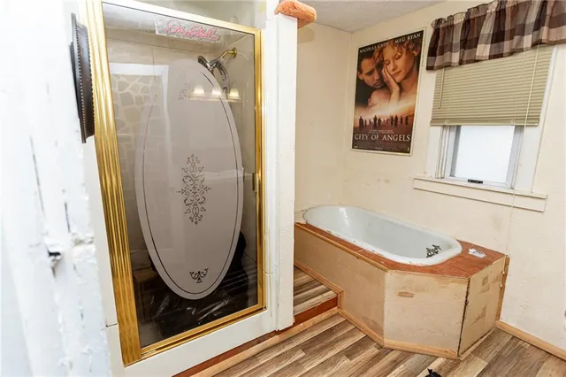 an entryway with wooden floor and mirror