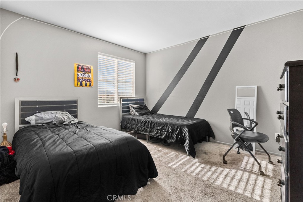 6949 Beale Road Palmdale, CA 93552 - Photo 19 of 32 a bedroom with two beds and a large window