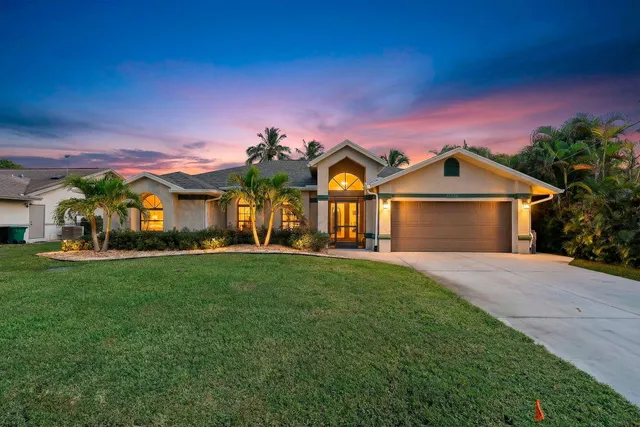 a front view of a house with yard and green space