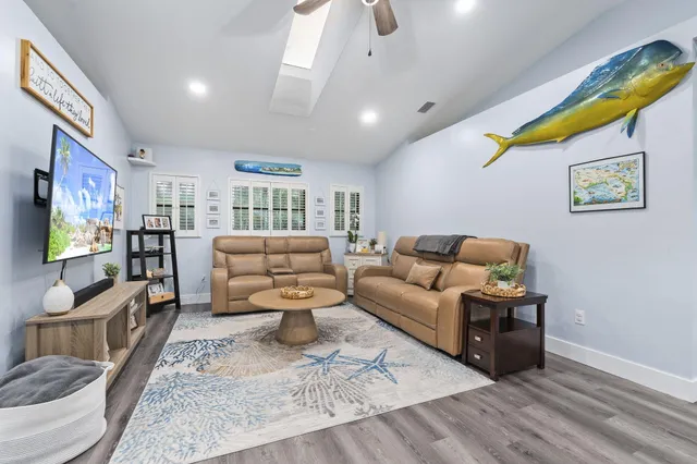 a living room with furniture and kitchen view