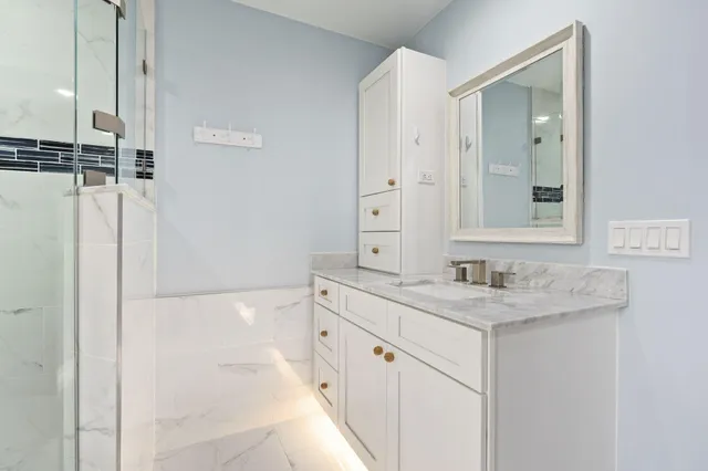 a spacious bathroom with a sink and a mirror