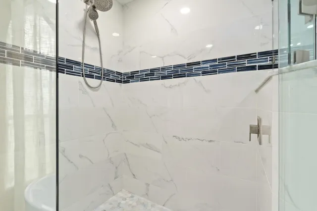 a bedroom with a bed and a flat tv screen on dresser