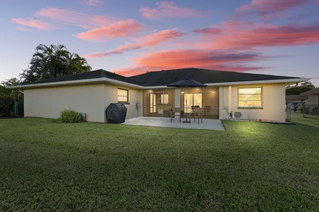a front view of a house with a garden and yard