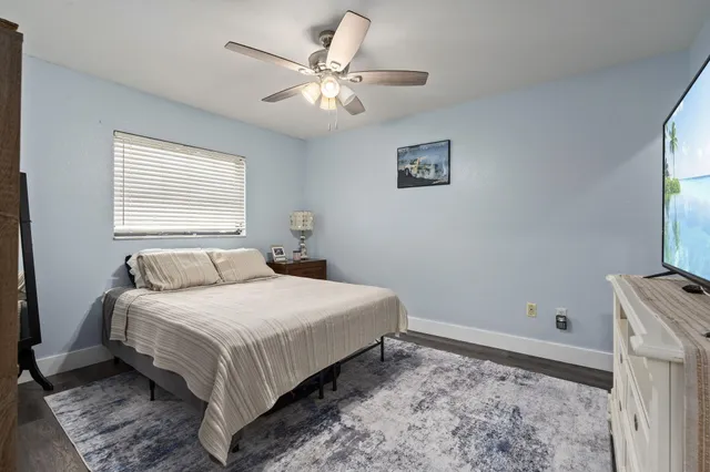 a view of an empty room with a chandelier fan