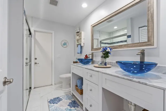 a bedroom with a dresser and a window
