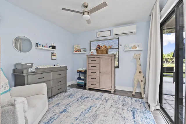 a dining room with furniture and a floor to ceiling window