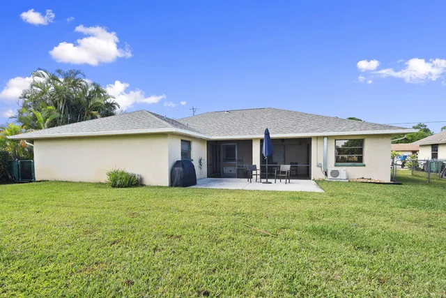 a front view of a house with a garden and yard