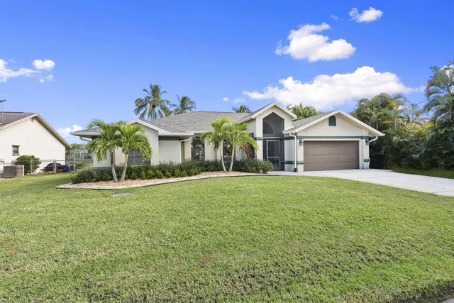 an aerial view of a house with yard swimming pool and outdoor seating