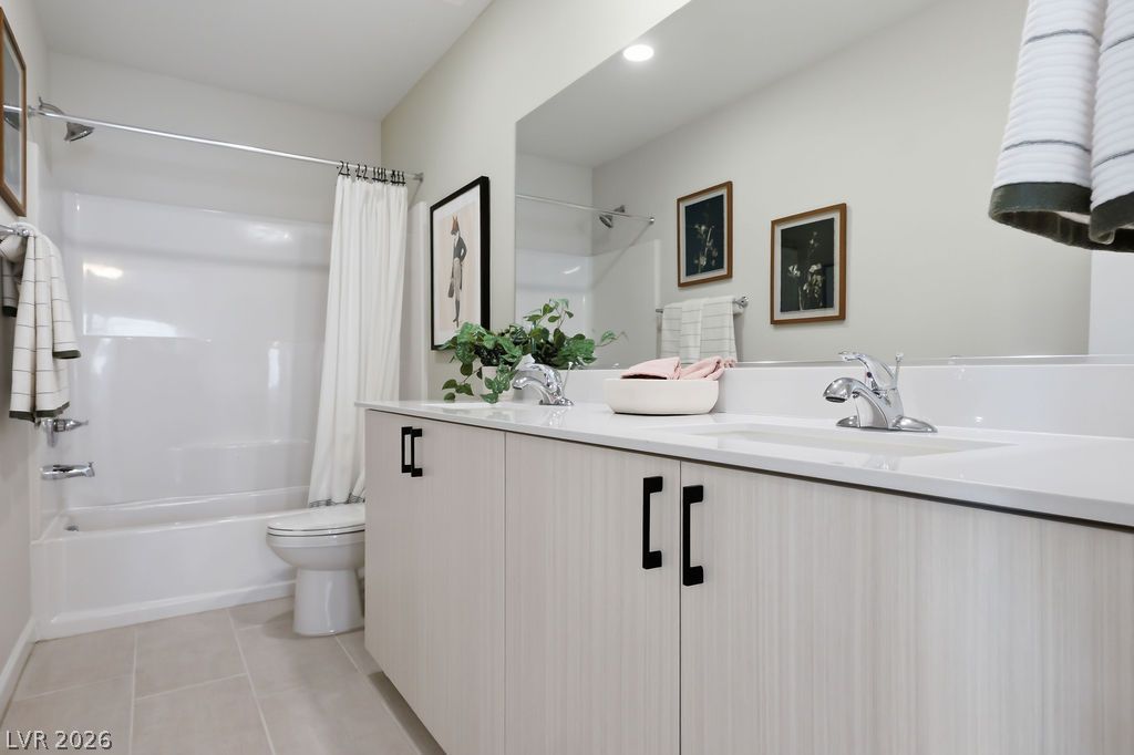 913 Cadence View Way Henderson, NV 89011 - Photo 33 of 46 A well-lit bathroom with light-toned cabinets and a simple, clean aesthetic.