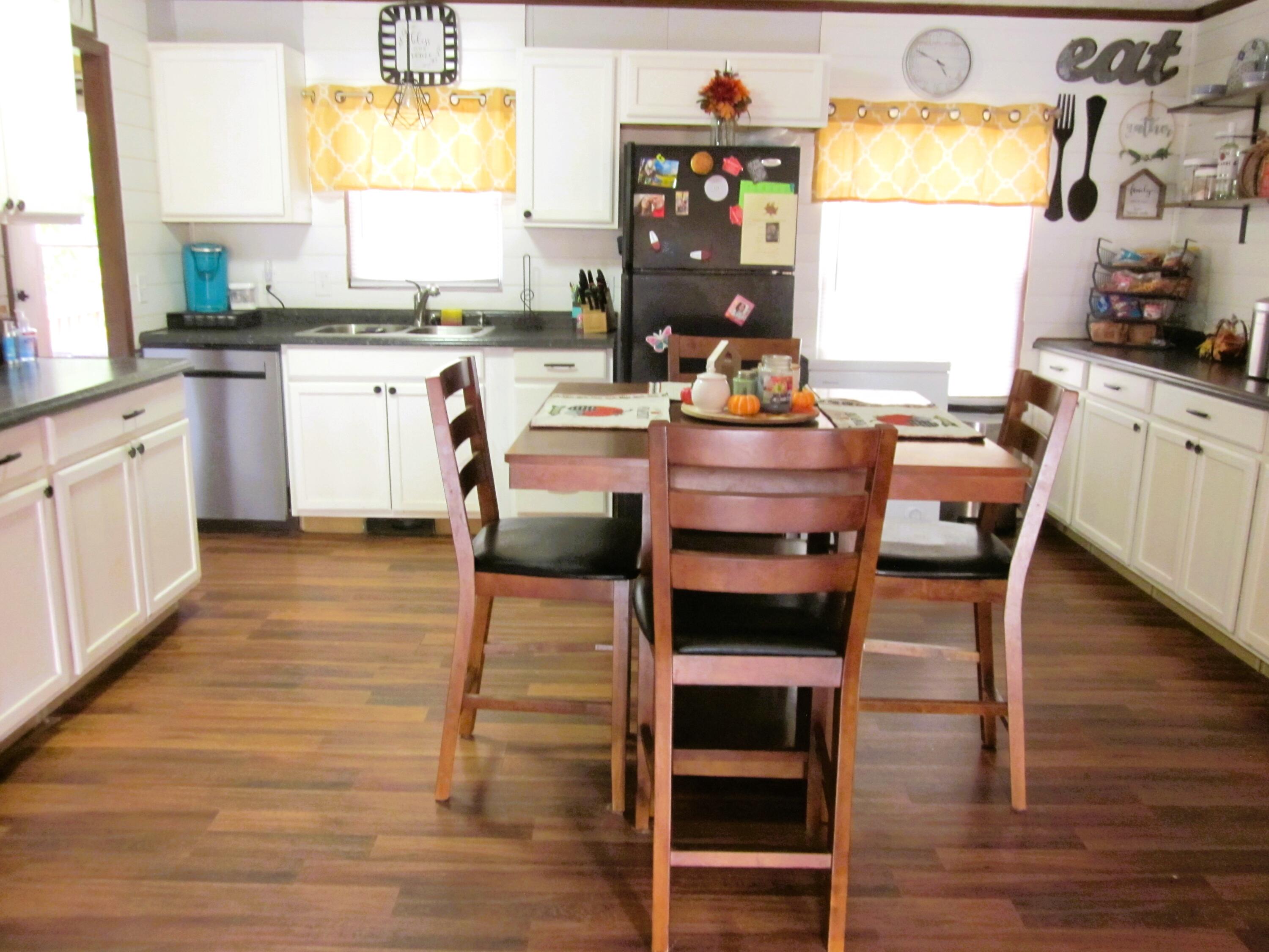 177 Carolina Road Rocky Mount, VA 24151 - Photo 11 of 24 a kitchen with stainless steel appliances granite countertop a table chairs stove and sink