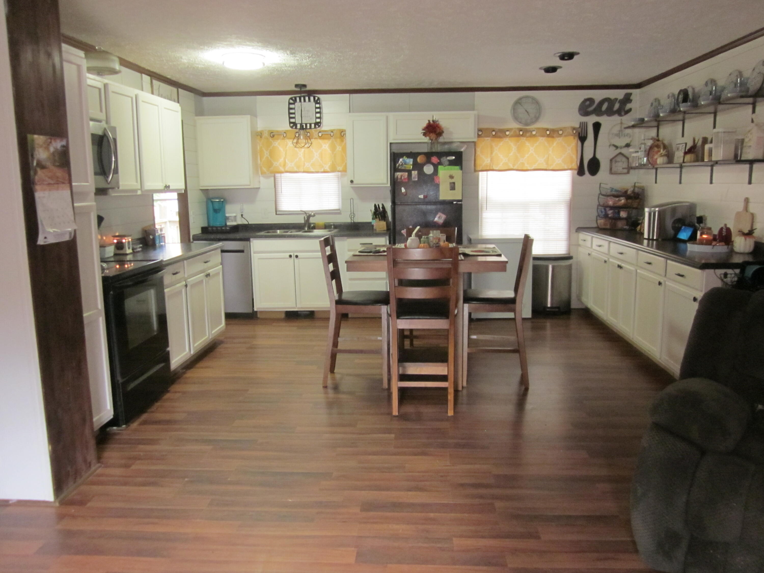 177 Carolina Road Rocky Mount, VA 24151 - Photo 8 of 24 a kitchen with stainless steel appliances kitchen island granite countertop a table chairs sink and cabinets