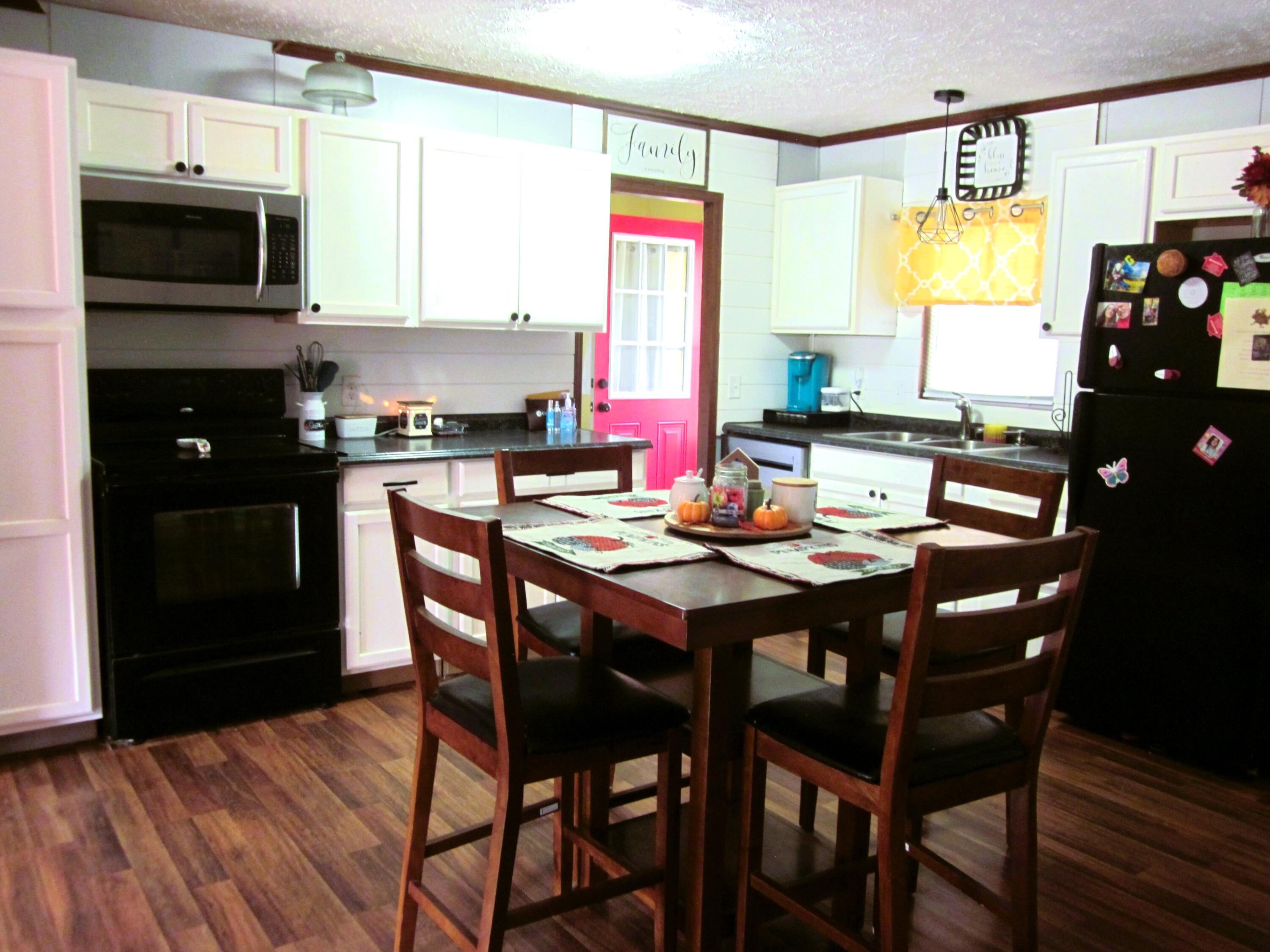 177 Carolina Road Rocky Mount, VA 24151 - Photo 9 of 24 a kitchen with stainless steel appliances granite countertop a stove a refrigerator a dining table and chairs