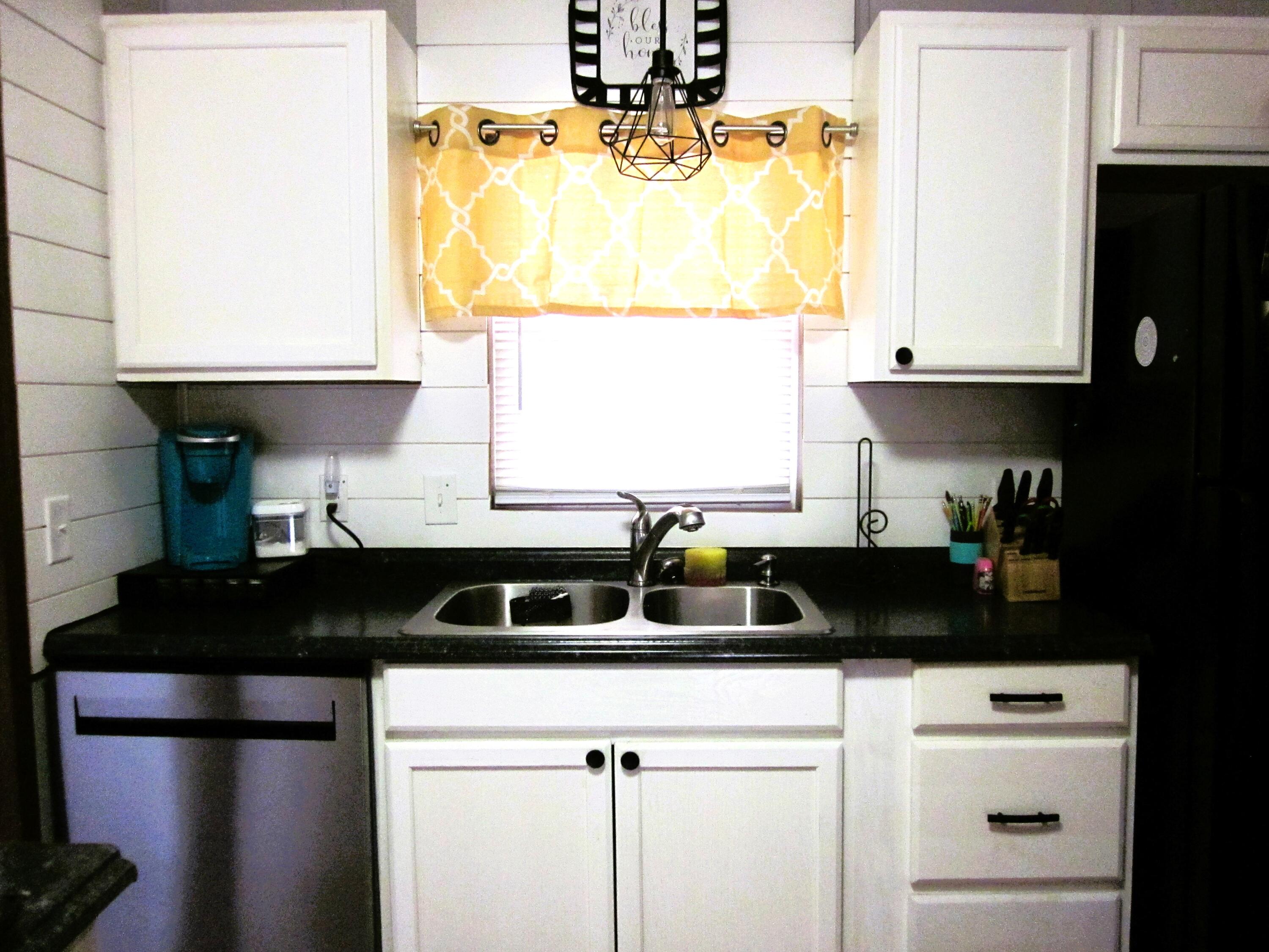 177 Carolina Road Rocky Mount, VA 24151 - Photo 10 of 24 a view of a kitchen with a sink and wooden cabinets
